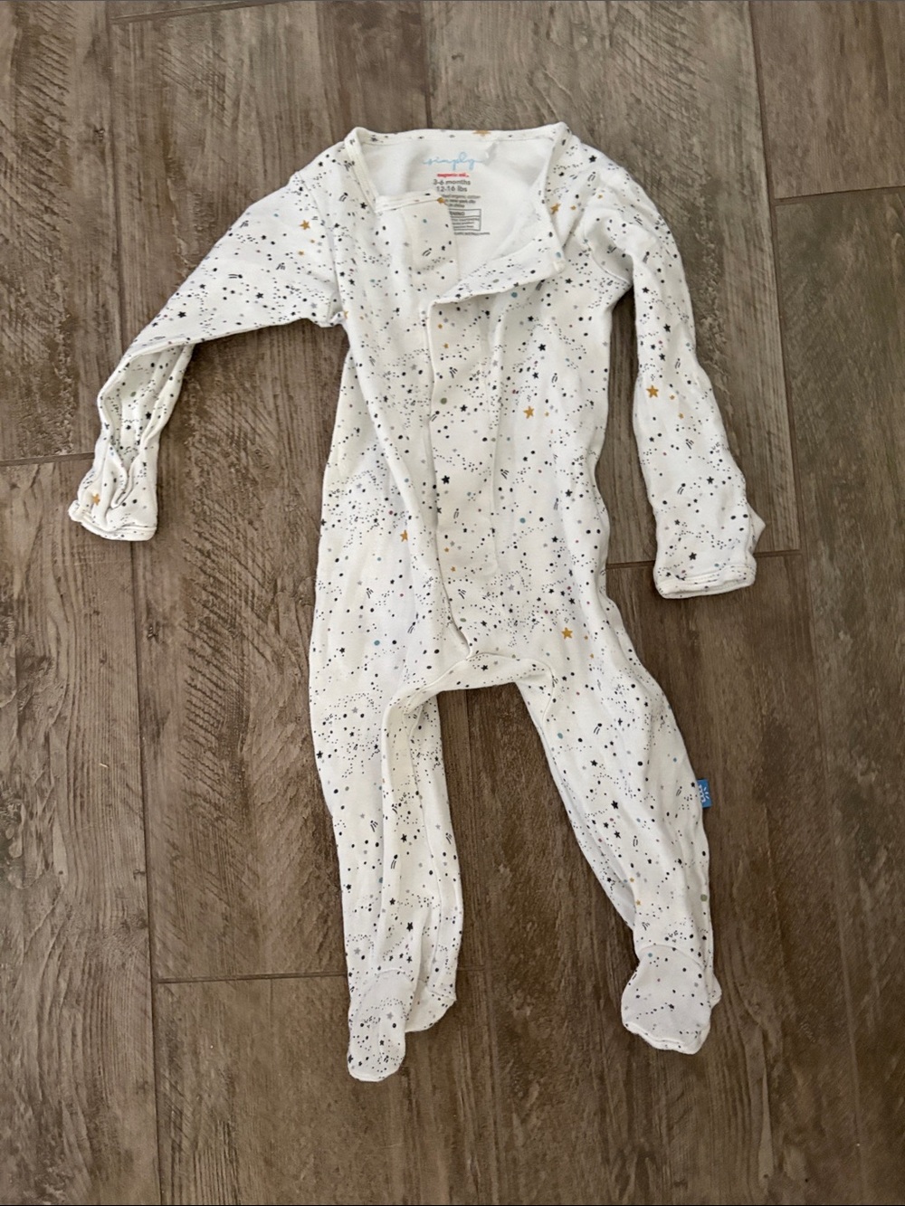 Magnetic Me White Footed One-Piece with Black and Gold Star Print